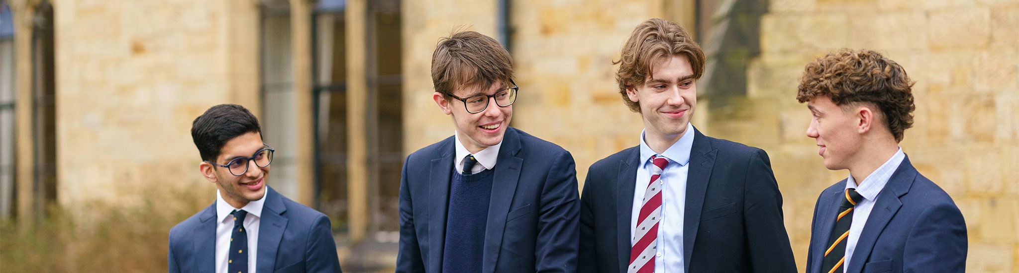 Boys walking outside front of school